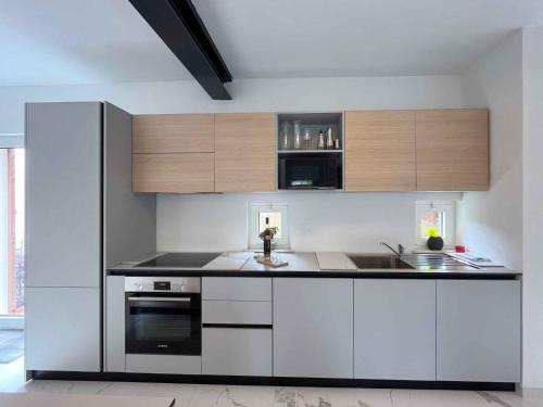 a kitchen with white appliances and wooden cabinets at Holiday home in Punat - Insel Krk 54520 in Punat