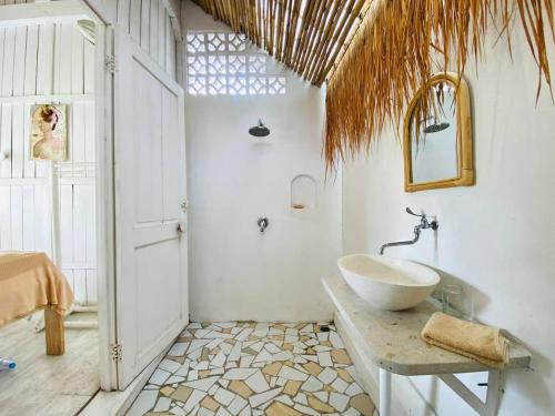 a bathroom with a sink and a tub in a room at Villa Stari in Canggu