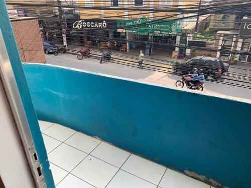 a view from a window of a street with people riding motorcycles at Apartamento Aconchegante no Bairro Alto in Teresópolis