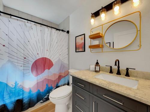 a bathroom with a toilet and a sink and a mirror at Boulder Apache Junction in Apache Junction