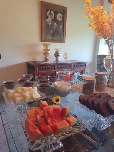 a table topped with lots of different types of food at Pousada Valle do Sol in Campos do Jordão