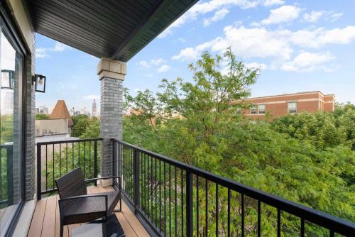 a balcony with a chair and a view of a building at New 3Bed 2Bath Condo with Parking by United Center in Chicago
