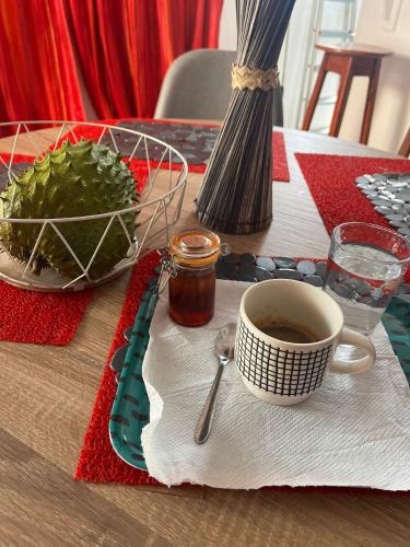 a table with a cup of coffee on a table at Villa Ludger-Rose in Le Moule