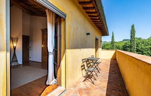 two chairs sitting on the balcony of a house at Amazing Home In Barberino Tavarnelle in Barberino di Val dʼElsa