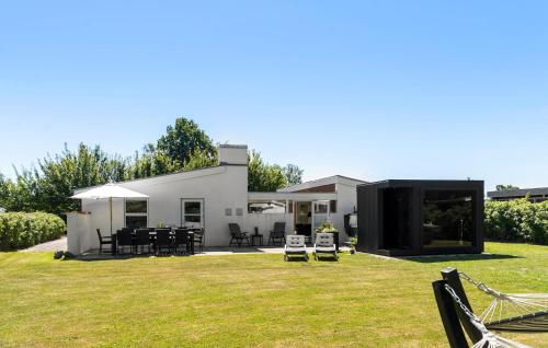 a modern house with a large yard with grass at Gorgeous Home In Sydals With Sauna in Neder Lysabild