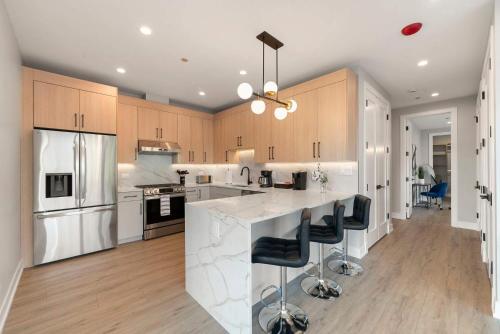 a kitchen with white counter tops and wooden cabinets at New Build in Pilsen Spacious 2 Bed 2 Bath Unit in Chicago