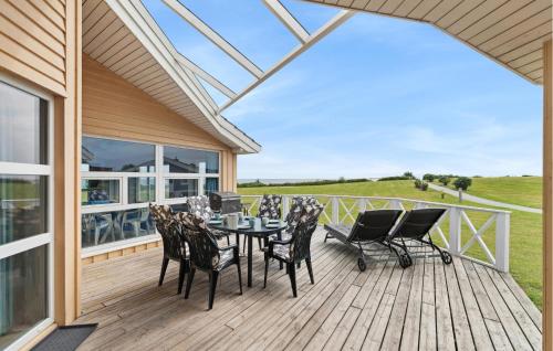 a patio with a table and chairs on a deck at Strandblick 27 in Schönhagen