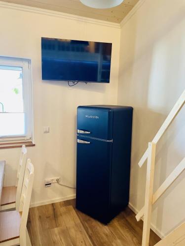 a blue refrigerator in a room with a tv at Ziegelgarten in Schwanau