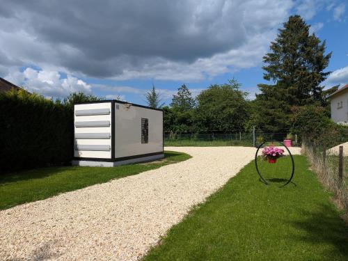 a tiny house sitting on the side of a gravel driveway at Gîte Moderne et Chaleureux pour 4 à Milly-sur-Bradon - FR-1-585-177 in Milly-sur-Bradon
