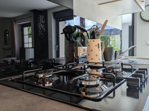 a kitchen counter with a stove top oven in a kitchen at Gîte Moderne et Chaleureux pour 4 à Milly-sur-Bradon - FR-1-585-177 in Milly-sur-Bradon