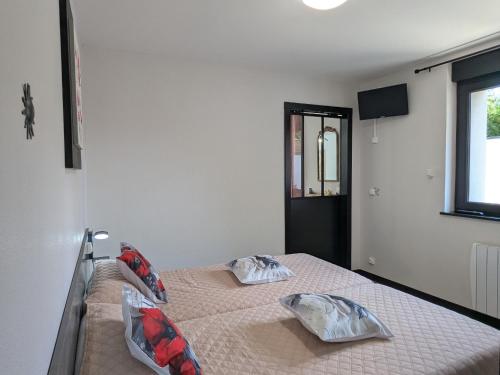 a bedroom with a bed with two pillows on it at Gîte Moderne et Chaleureux pour 4 à Milly-sur-Bradon - FR-1-585-177 in Milly-sur-Bradon