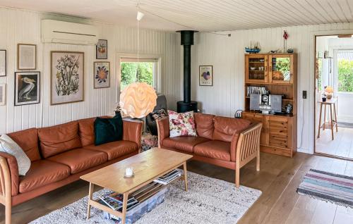 a living room with a couch and a coffee table at Gorgeous Home In Gilleleje With Wifi in Gilleleje