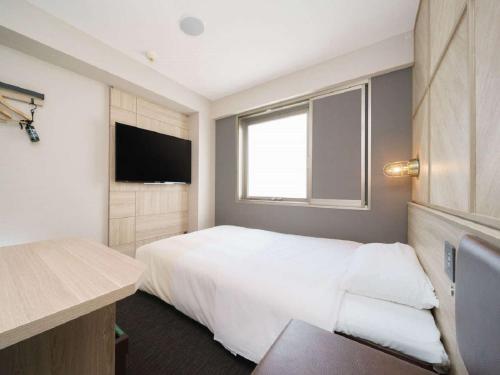 Postel nebo postele na pokoji v ubytování Super Hotel Umeda Higobashi