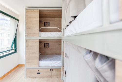a bedroom with a bunk bed and a window at A Room In The City Hostel in San Sebastián