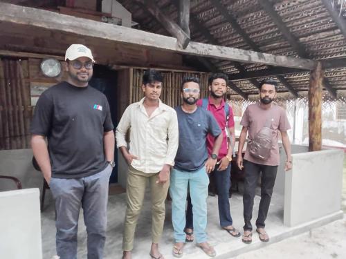a group of men standing in front of a building at Delft Cultural Home Stay in Delft East
