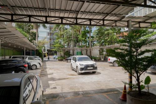 a parking lot with cars parked in it at Noden Hotel & Apartment in Phnom Penh