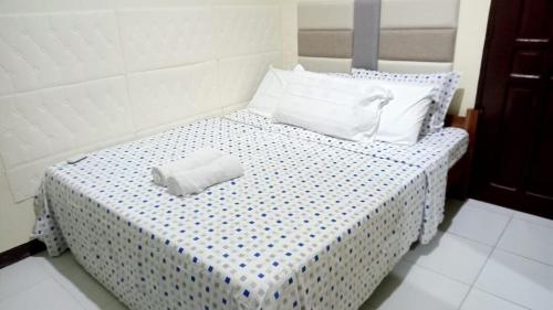 a bed with two pillows on top of it at Tropical Garden Apartment in Moalboal