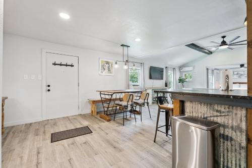 a kitchen and living room with a table and chairs at Spacious Okc Studio Fairgrounds & Downtown #14b in Oklahoma City