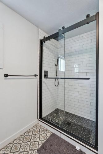 a shower with a glass door in a bathroom at Spacious Okc Studio Fairgrounds & Downtown #14b in Oklahoma City