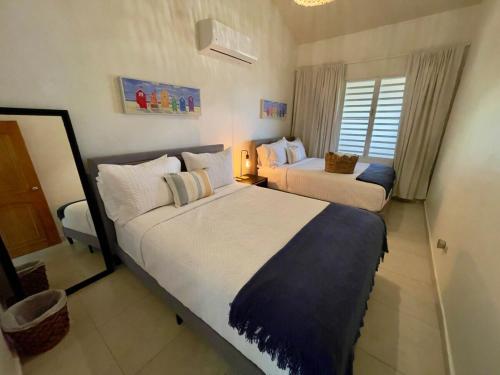 a hotel room with two beds and a window at Villa Las Tres Gaviotas I in Salinas