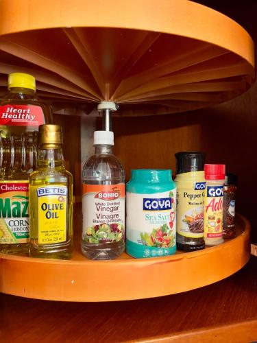 a shelf with a bunch of different types of condiments at Villa Las Tres Gaviotas I in Salinas