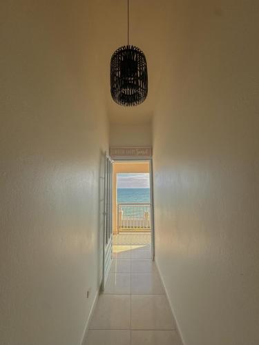 a hallway with a view of the ocean and a chandelier at Villa Las Tres Gaviotas I in Salinas