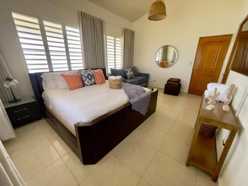 a bedroom with a bed and a couch at Villa Las Tres Gaviotas I in Salinas