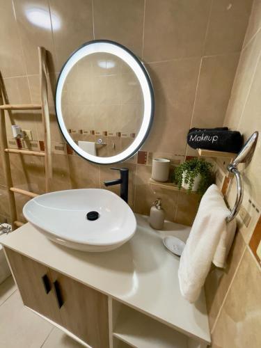 a bathroom with a white sink and a mirror at Villa Las Tres Gaviotas I in Salinas