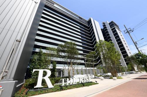 a tall building with a raffles hotel sign on it at THE RISE Osaka Universal Bayside in Osaka