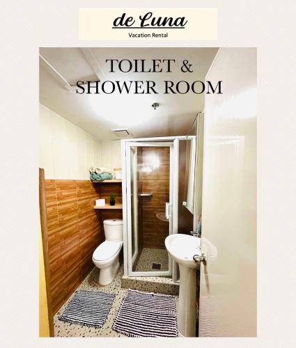 a bathroom with a toilet and a shower room at de Luna Vacation Rental in Davao City