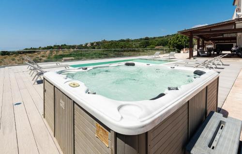 a hot tub on the deck of a house at 5 Bedroom Awesome Home In Casalvelino in Casal Velino