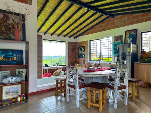 a kitchen with a table and chairs in a room at Casa de Campo en San Pedro in San Pedro
