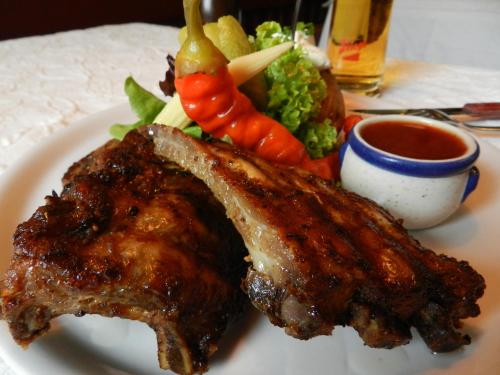 a plate of food with meat and vegetables on a table at Gasthof Wiesenhof in Strobl