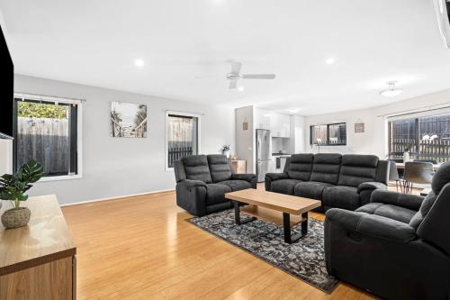 a living room with two couches and a table at Geelong ReGen Living near City in Bell Post Hill