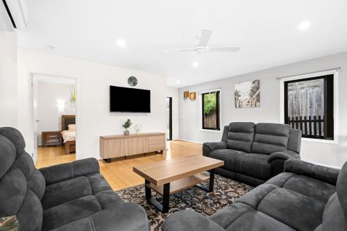 a living room with two couches and a table at Geelong ReGen Living near City in Bell Post Hill