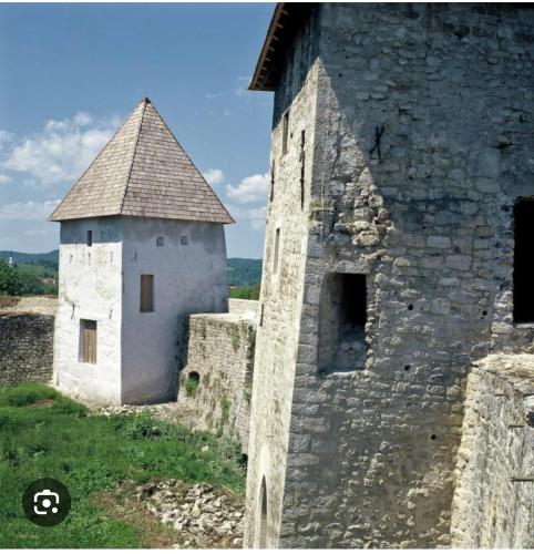 an old building with a tower on the side of it at Camping Nori-Una in Hrvatska Kostajnica