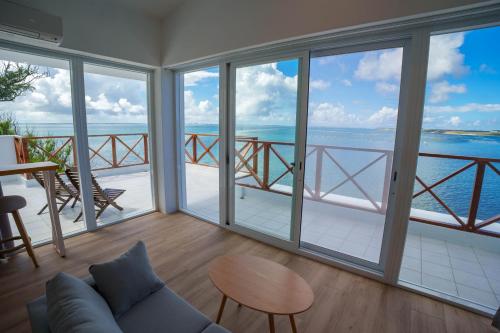 a living room with large windows and a view of the ocean at 與浪共舞 in Xiyu