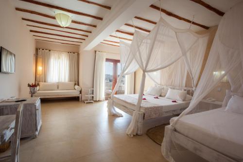 a bedroom with a bed with a mosquito net at Seven Islands Resort in Watamu