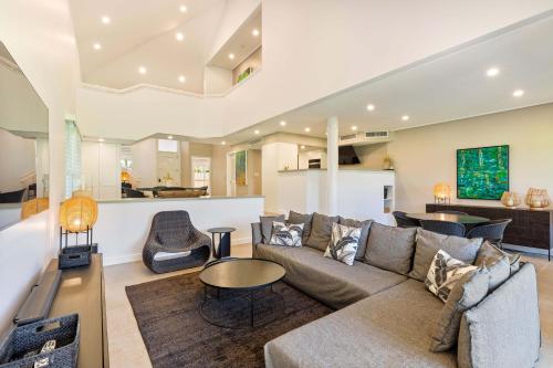 a living room with a couch and a table at Mirage Resort Villa 432 with access to Sheraton Facilities in Port Douglas