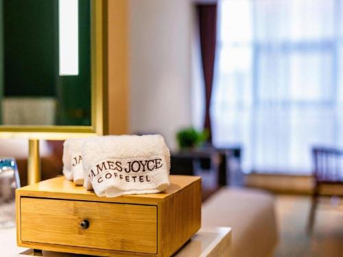 a pillow with a sign on it sitting on a table at James Joyce Coffetel· Xianyang Renmin Road Central Square Store in Xianyang