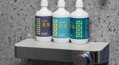 three bottles of water are sitting on a shelf at City Comfort Inn Shiyan Wudang Mountain in Danjiangkou