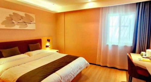 a bedroom with a large bed and a window at GreenTree Inn Express Chuzhou Langya District Government Chuhe Road in Chuzhou