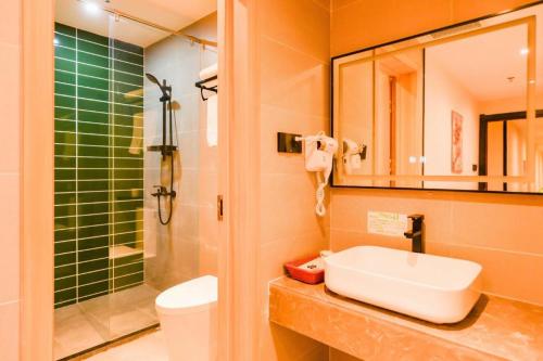a bathroom with a sink and a shower and a toilet at GreenTree Inn Express Lanzhou West Passenger Station Lanzhou Center in Lanzhou