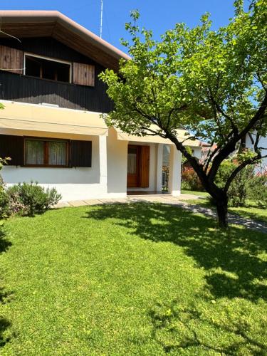a house with a green lawn in front of it at Casa degli Albicocchi - near Venice - whole house with garden and free Prkg in Spinea
