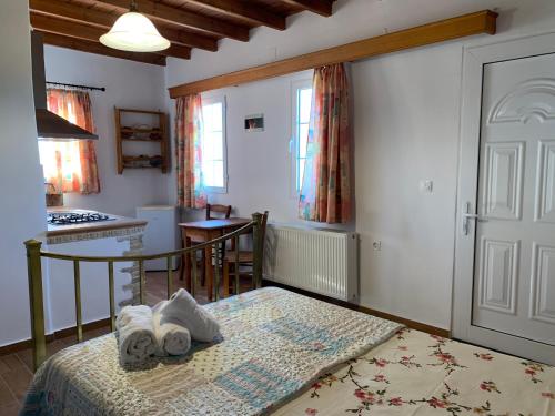 a bedroom with a bed with towels on it at Nηρηις in Agia Marina