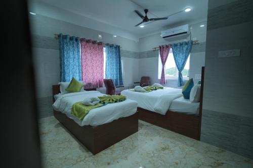 a hotel room with two beds and a mirror at Hotel Mirka Plaza in Bhubaneshwar
