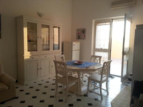 a kitchen with a table and chairs and a refrigerator at Alphi's Home Nebida in Nebida