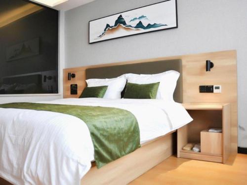 Ένα ή περισσότερα κρεβάτια σε δωμάτιο στο Green Tree Inn Anhui Tianchang Economic Development Zone