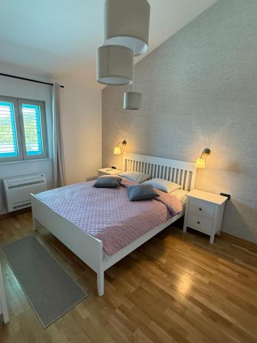 a bedroom with a bed with two pillows on it at Villa Maluso in Budva