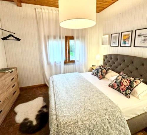 a bedroom with a bed with a dog laying on it at Casa degli Albicocchi - near Venice - whole house with garden and free Prkg in Spinea
